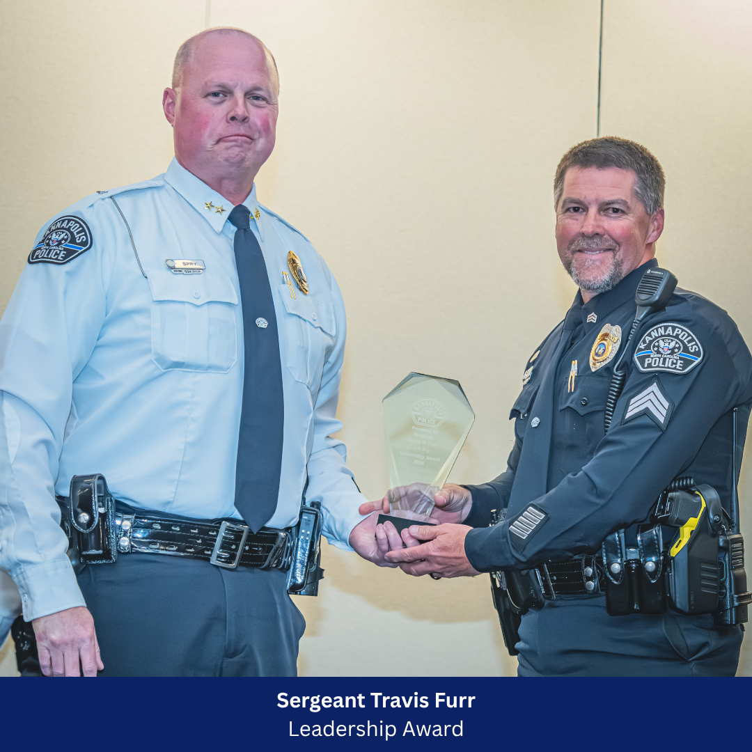 Travis Furr receiving award from Chief Spry 